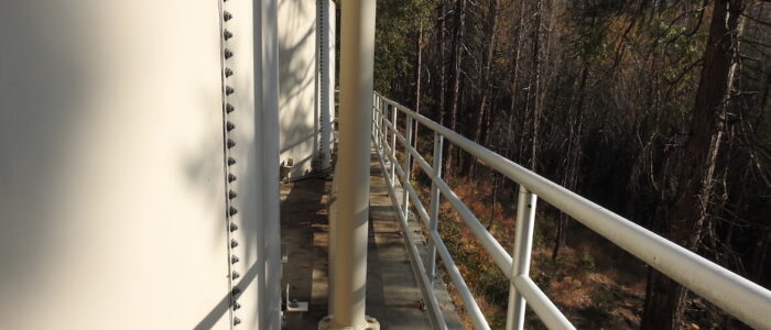 Side view of water tanks with guard rail