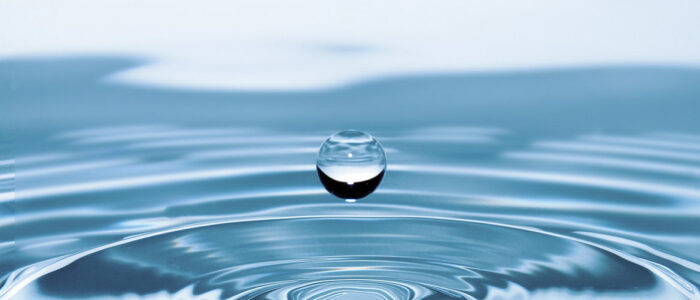 closeup of drop of water making a wave